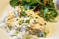 a white plate topped with rice and salad