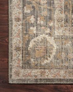 an area rug with wood flooring and a brown, beige and orange color scheme