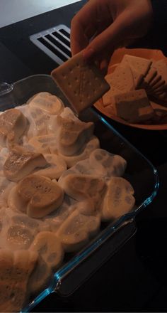 a person is cutting up some food in a pan