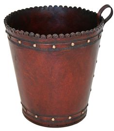 a brown leather bucket with rivets on the sides