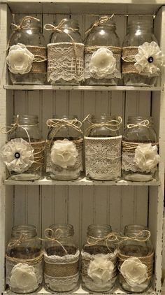 the shelves are filled with glass jars and lace doilys, tied with twine