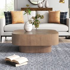 a living room scene with focus on the coffee table and sofa in the foreground