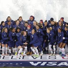 the u s women's soccer team poses for a group photo with their trophy