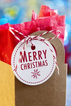 a brown paper bag with a merry christmas tag on it