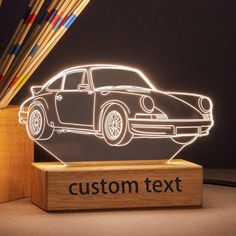 a car is shown on a wooden stand with the word'custom text'underneath it