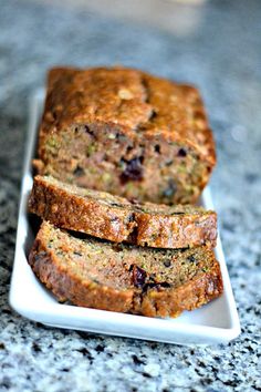 sliced loaf of fruit bread on a white plate