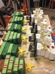 many boxes are lined up on a table with stars and ribbons tied around the edges