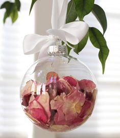 a glass ornament filled with flowers on top of a table