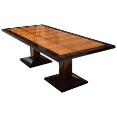 a wooden table sitting on top of a black base with two square bases in front of it