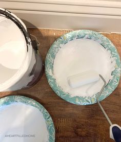 two plates with white and blue designs on them, one has a spatula in it