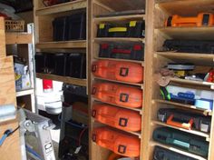 there are many different tools in the storage area on this shelf and one is orange