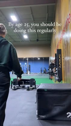 a man walking through a gym with an exercise bag in front of him and the words by age 25, you should be doing this regularly