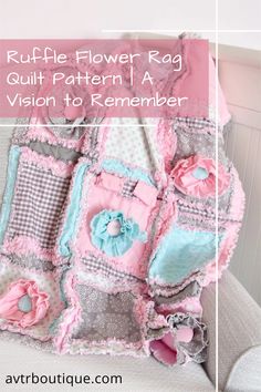 a pink and gray blanket with flowers on it, next to a white chair that has the words ruffle flower rag quilt pattern