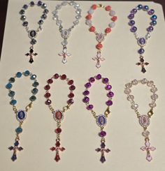 This 10 Decade Rosary is a perfect gift for a any special occasion and also a gift for First Communion   If for an adult it does has a clasp so it can be hung in the cars rear mirror. Mini Rosary Beads, Affordable Handmade Pink Rosary, Rosary Ideas, Purple Rosary With 8mm Beads, One Decade Rosary, Hand-strung Round Beads Rosary As A Gift, Mini Rosaries, Rosary Jewelry, Rear Mirror