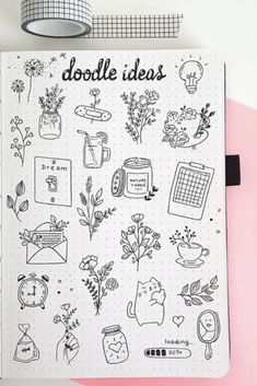 an open notebook with doodles on it and various things in the pages next to it