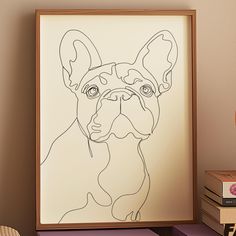 a drawing of a dog in a frame on a table