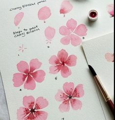 some watercolors are being used to paint pink flowers