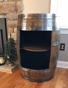 a wooden barrel shelf next to a fire place in a room with wood flooring