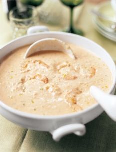 a white bowl filled with soup sitting on top of a table