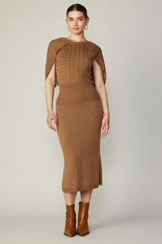 Make an effortless transition into cooler weather with a figure-accentuating sweater dress. Done in a sophisticated caramel brown shade, this one has a cabled design knitted into the bodice and cape-like piecing draped over the shoulders. Side slits complete the look, offering easy movement and a glimpse of leg. •Cable Camel Sweater Dress, Camel Sweater, Brown Sweater Dress, Midi Sweater Dress, Button Shirt Dress, Cape Sweater, Layered Sweater, Elegant Midi Dresses, Brown Shade