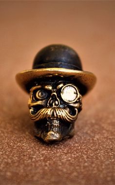 a small skull wearing a hat on top of a table