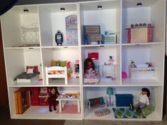 a doll house with lots of furniture and accessories on it's shelves in the living room