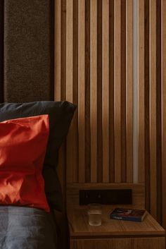 a bed with a wooden head board and night stand