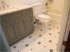 a white toilet sitting next to a bath tub in a bathroom