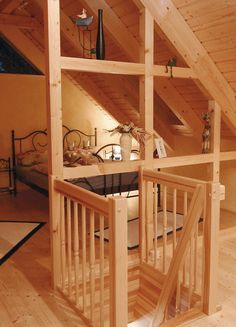 an attic bedroom with stairs leading up to the loft