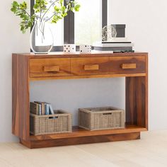 a wooden console table with two baskets on it and a mirror above the top shelf