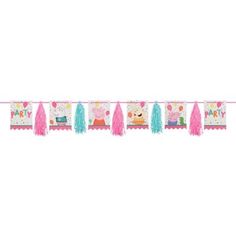 a pink and blue birthday banner with pom poms hanging from it's sides