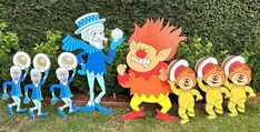 a group of cartoon characters standing next to each other in front of some bushes and trees