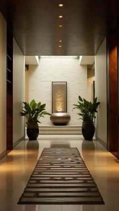 a hallway with two planters on either side of the wall and an art piece in the middle