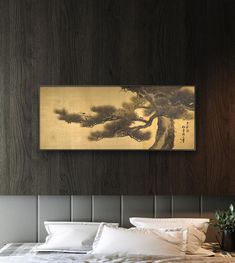 a bed sitting under a painting on top of a wooden wall