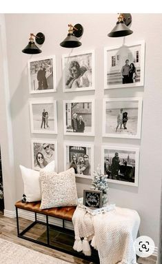 a living room with pictures on the wall and a bench in front of some christmas trees