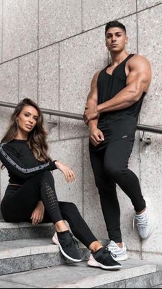 a man and woman sitting on some stairs