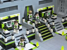 a lego set is shown with green and black accents, including two men on the stairs