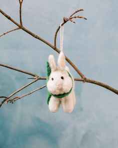 a stuffed animal hanging from a tree branch