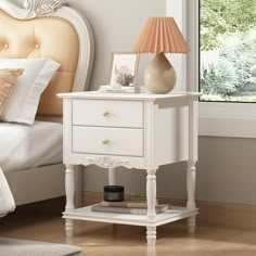 a white night stand with two drawers and a lamp next to it on a wooden floor