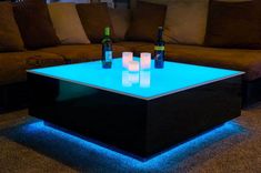 an illuminated coffee table with three bottles on it