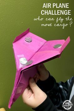 a child holding an origami airplane with the words, air plane challenge who can fly this most cargo?