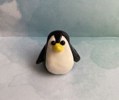 a penguin figurine sitting on top of a table