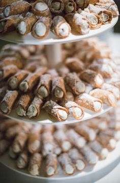 three tiered trays filled with pastries on top of each other