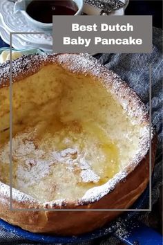 the best dutch baby pancake recipe is in this round baking dish with powdered sugar on top