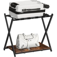 a white bag sitting on top of a wooden shelf next to a white purse and handbag