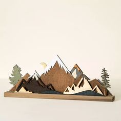 a wooden mountain scene with pine trees and moon