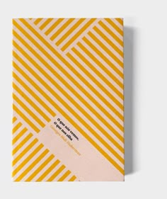 a yellow and white striped notebook with the title on it's front cover, which reads