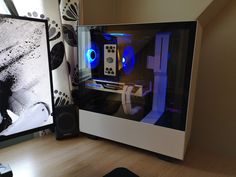 a desktop computer sitting on top of a wooden desk next to a monitor and speakers