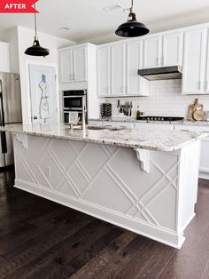 a kitchen with white cabinets and marble counter tops