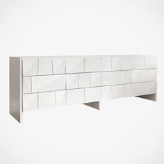 a white wall mounted shelf with several shelves